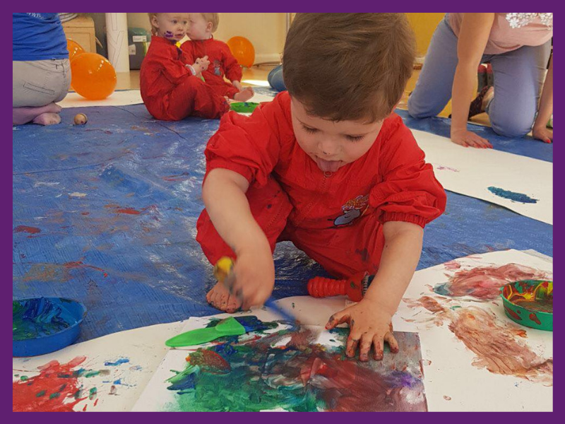 image of children in puddle suits creating artwork